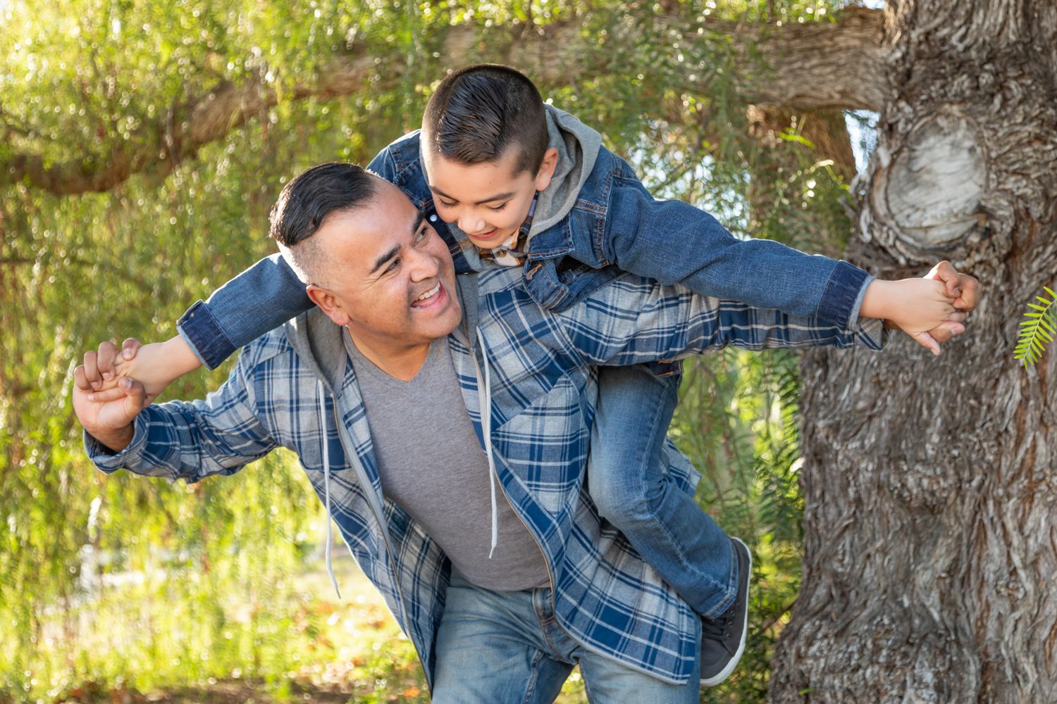 Father giving his child a piggyback ride outdoors