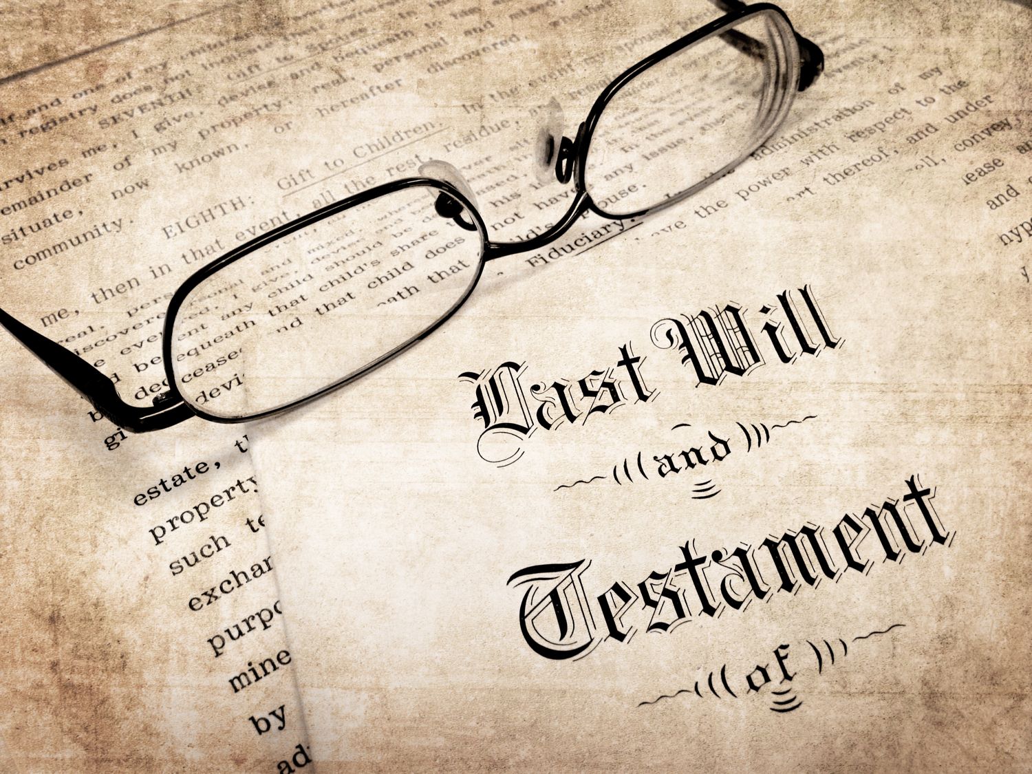 Reading glasses resting on a Last Will and Testament document