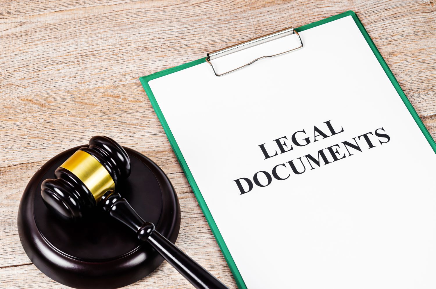Clipboard marked Legal Documents beside a wooden gavel