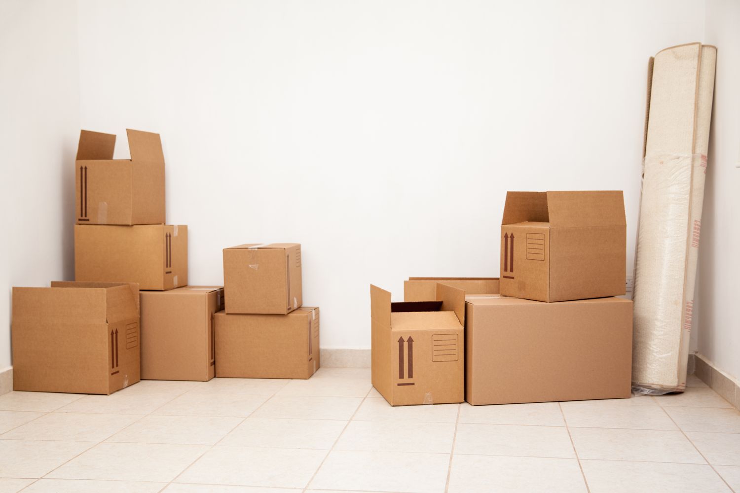 Stacked cardboard moving boxes in an empty room