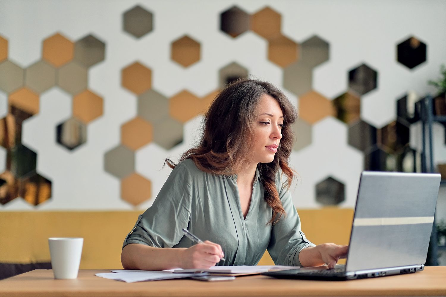 Woman working at a laptop in an office